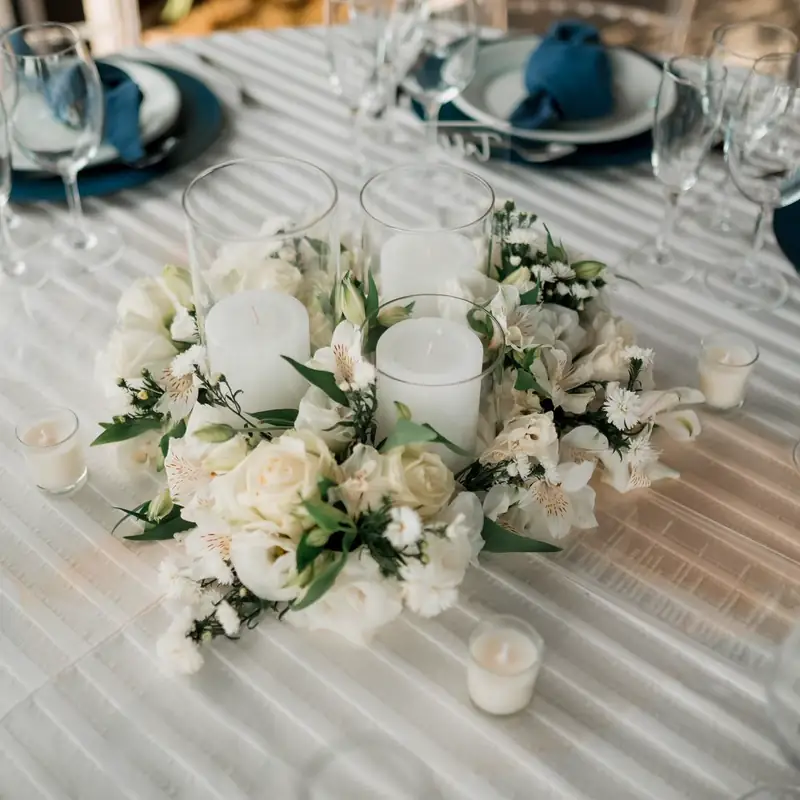 Aranjament floral alb așezat pe o masă elegantă